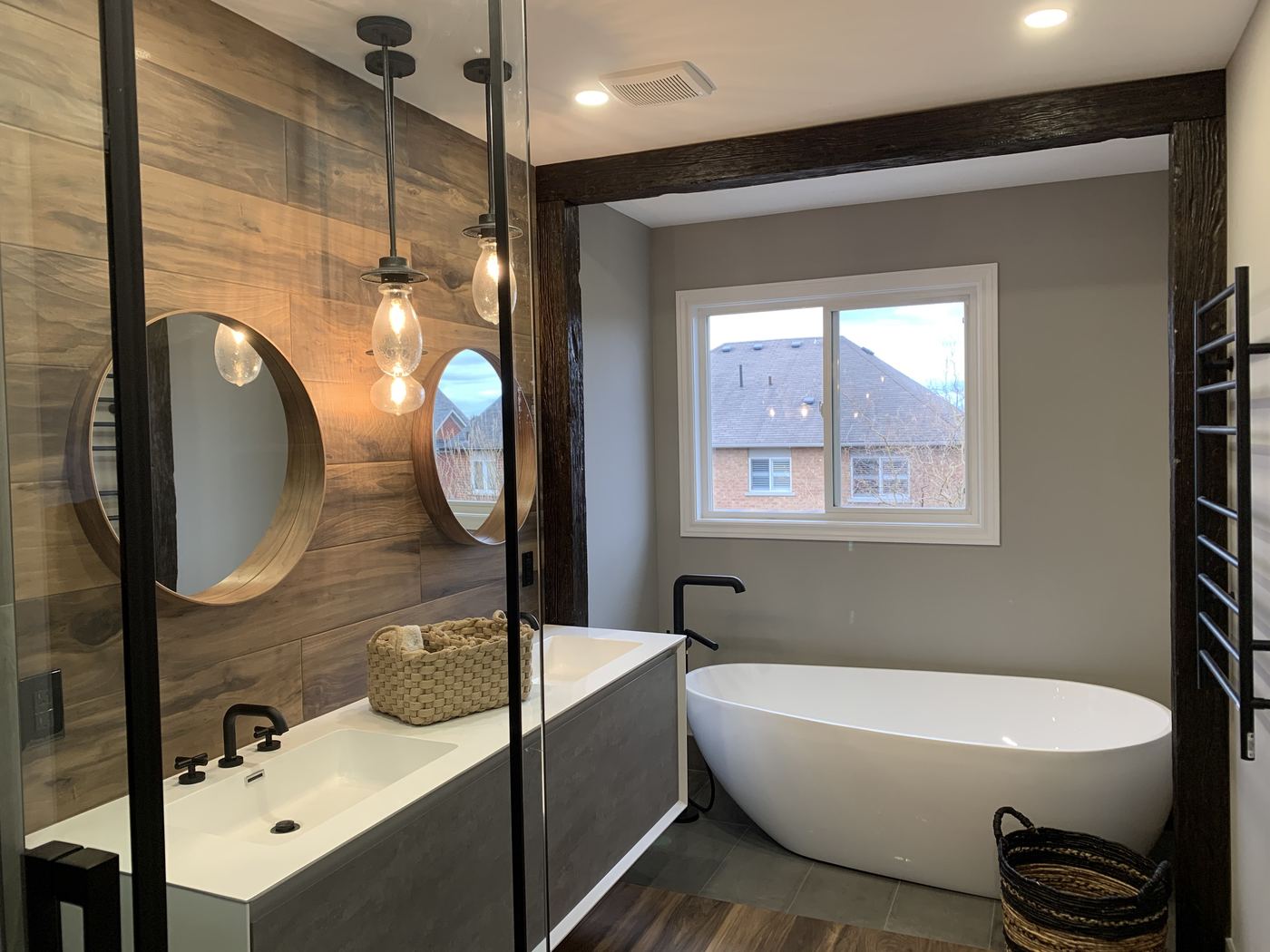 Bathroom renovation — rustic modern ensuite, freestanding tub, wood tile, dark beam